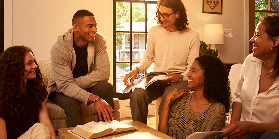 A group of young adults studying the Bible together